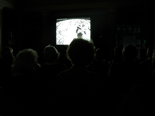 With the lights down, Schmitt's slides of the Moon's surface illustrate the lecture